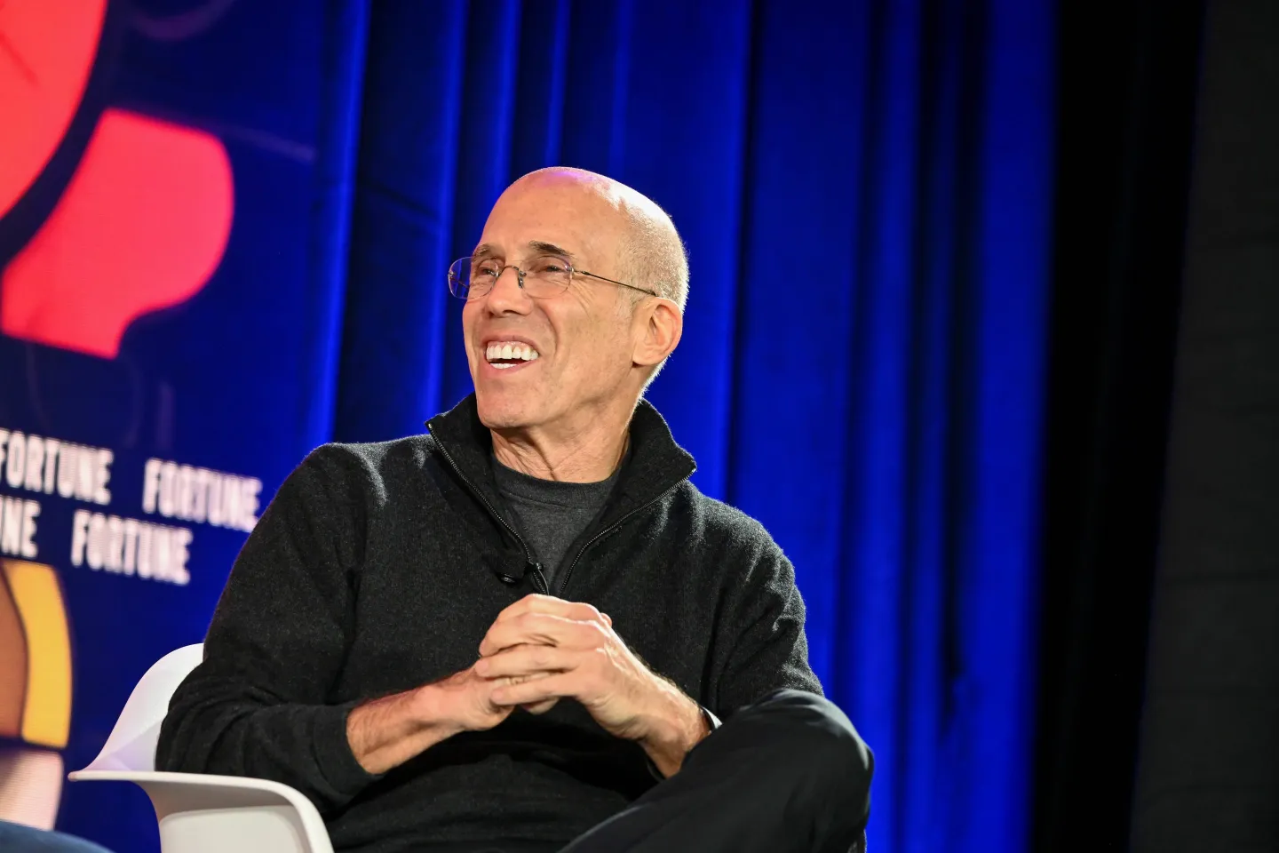 Jeffrey Katzenberg smiles during a discussion onstage at the Fortune Brainstorm AI 2024 event.