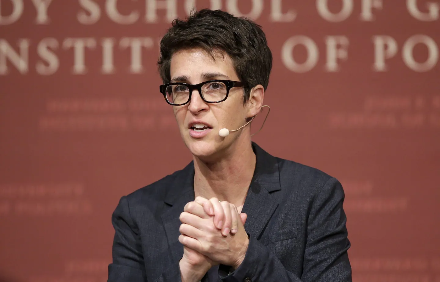 Rachel Maddow clasps her hands together