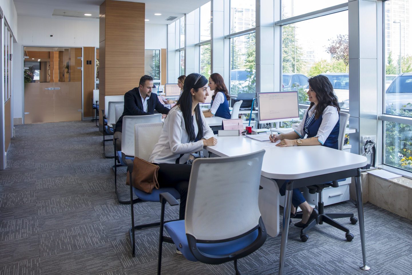 Employees helping customers in a bank.