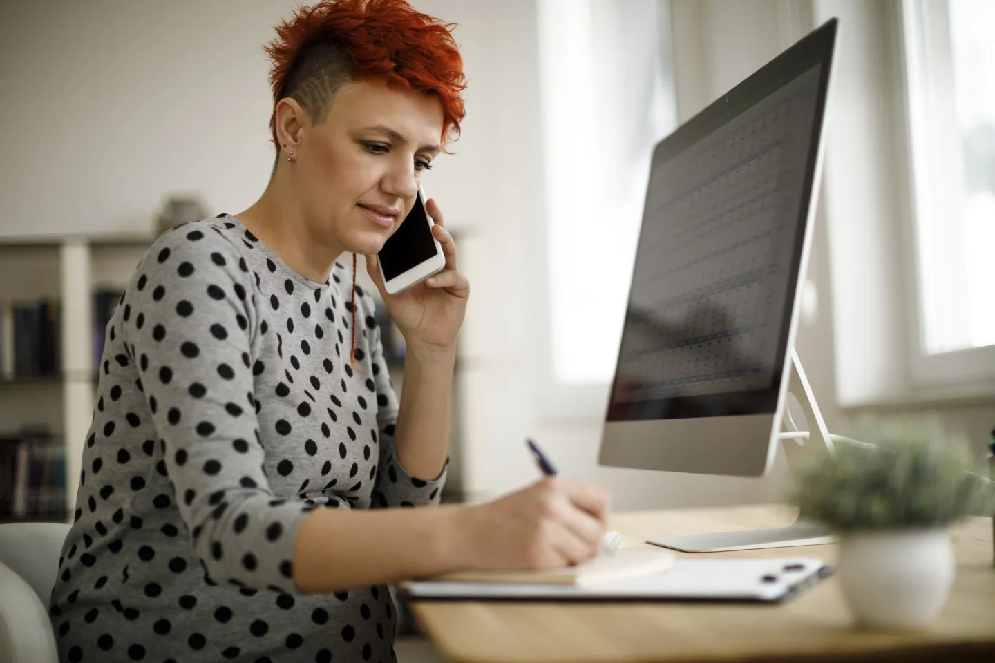 Pregnant woman working from home office.