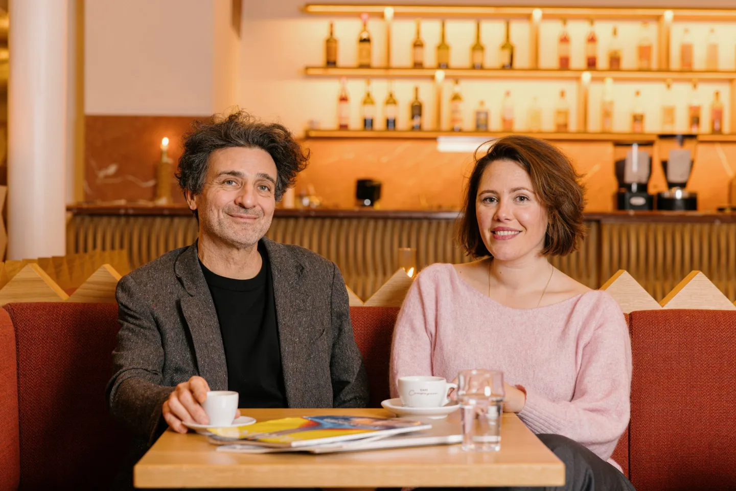 Photo of Robeauté cofounders Bertrand Duplat, left, and Joana Cortocci, sitting at a table in what looks like a bar or restaurant.