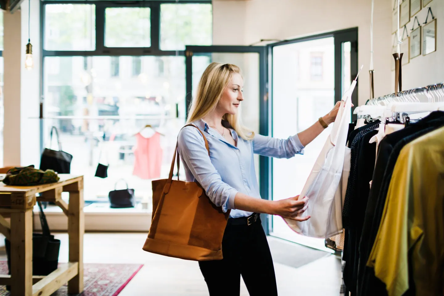 Woman looking at a shirt in a store