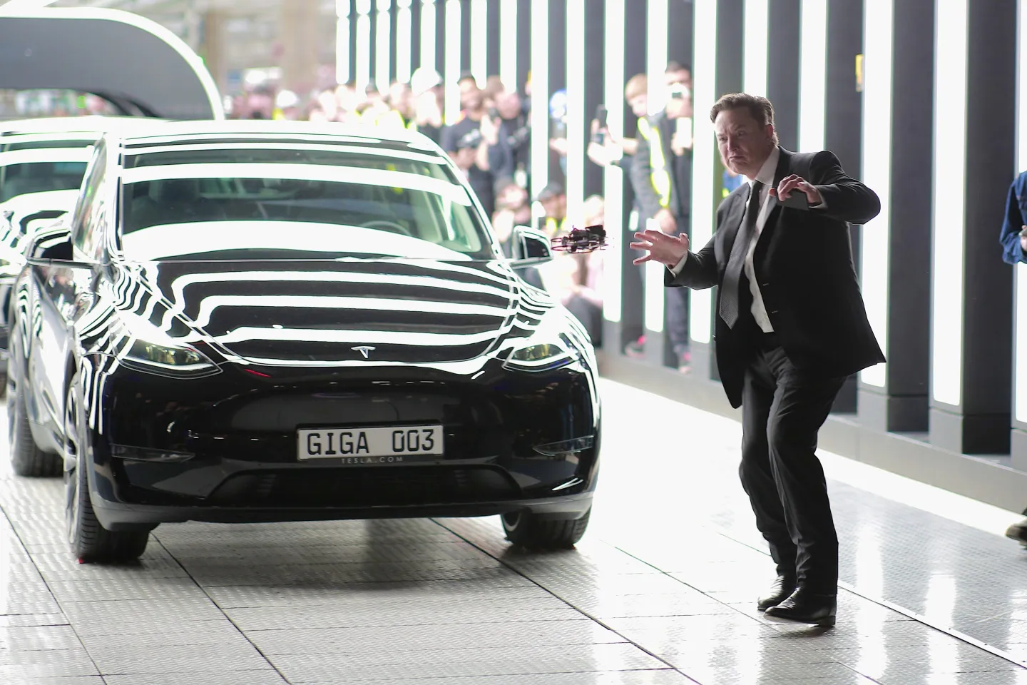 Elon Musk dances in front of a black Tesla