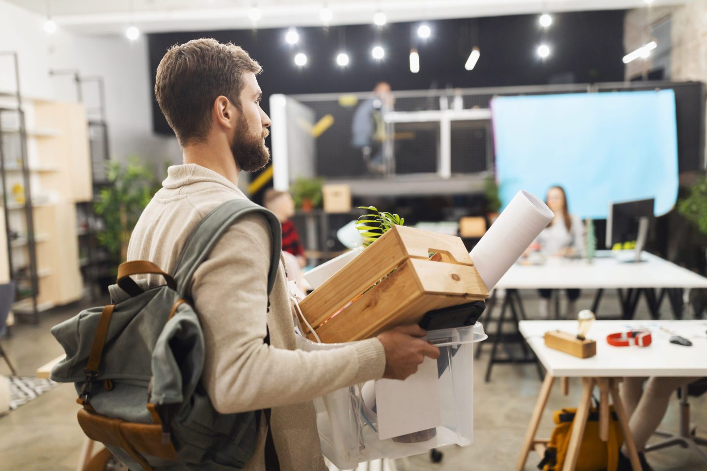 Corporate worker is fired, leaves office with desk belongings.