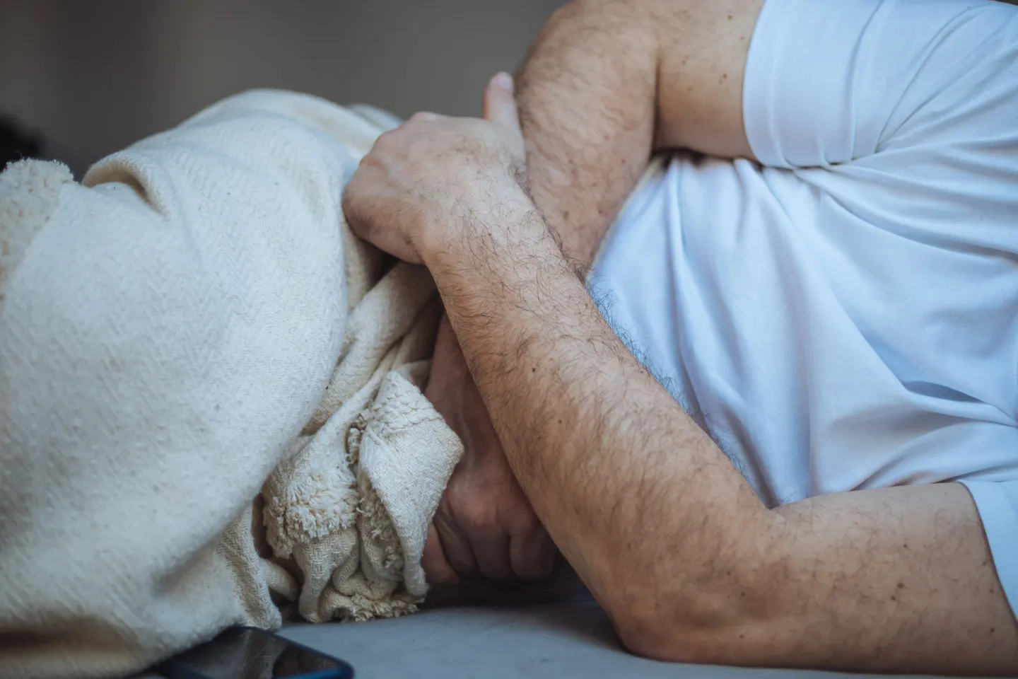 Unrecognizable man stomach pain