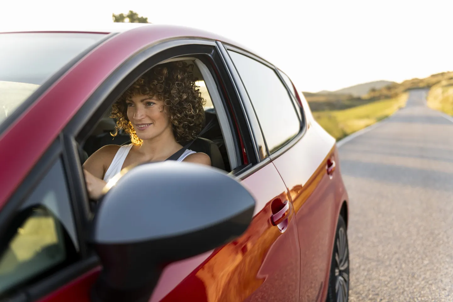 Woman sitting in the driver&#039;s seat of a car