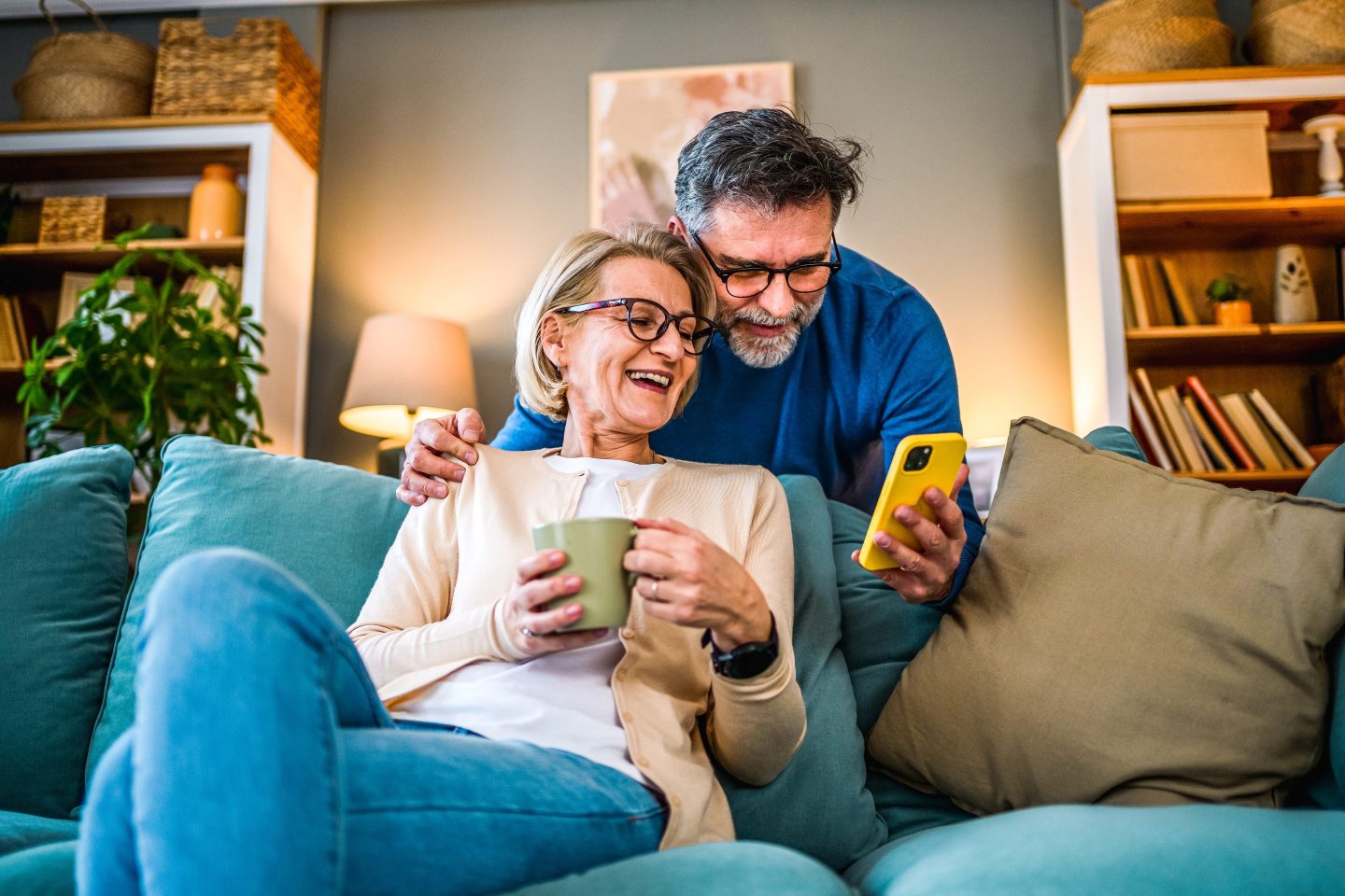 Mature couple using mobile phone.