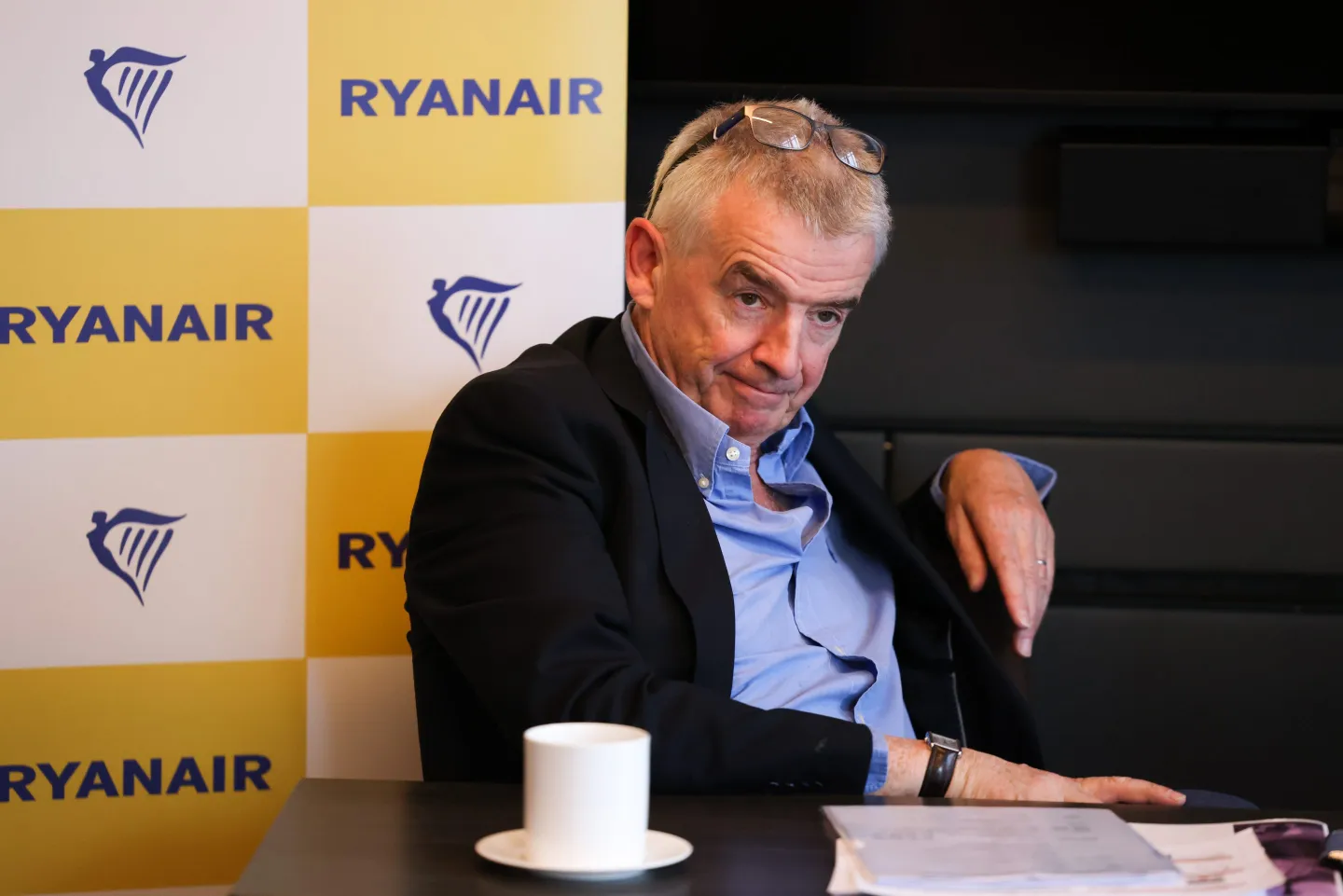 Ryanair ceo Michael O'Leary sitting by a table