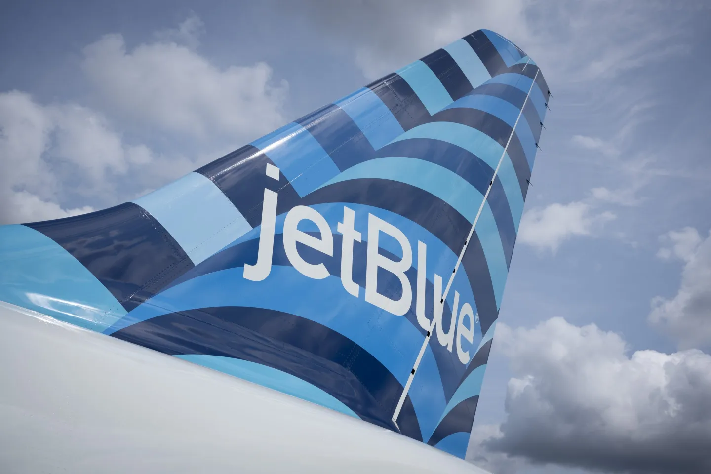 Close up of the JetBlue logo on the fin of an airplane