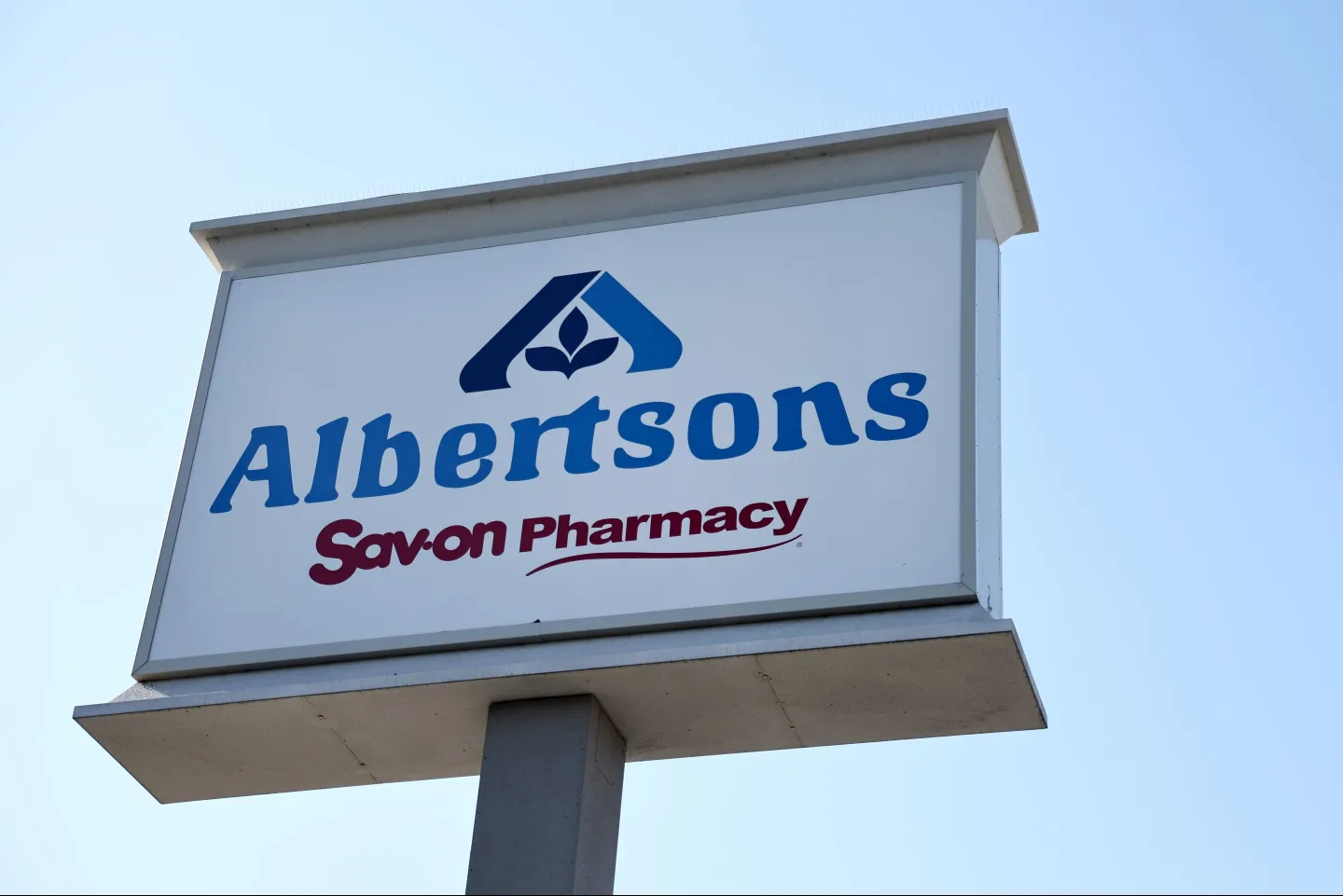 A sign for Albertsons against a blue sky