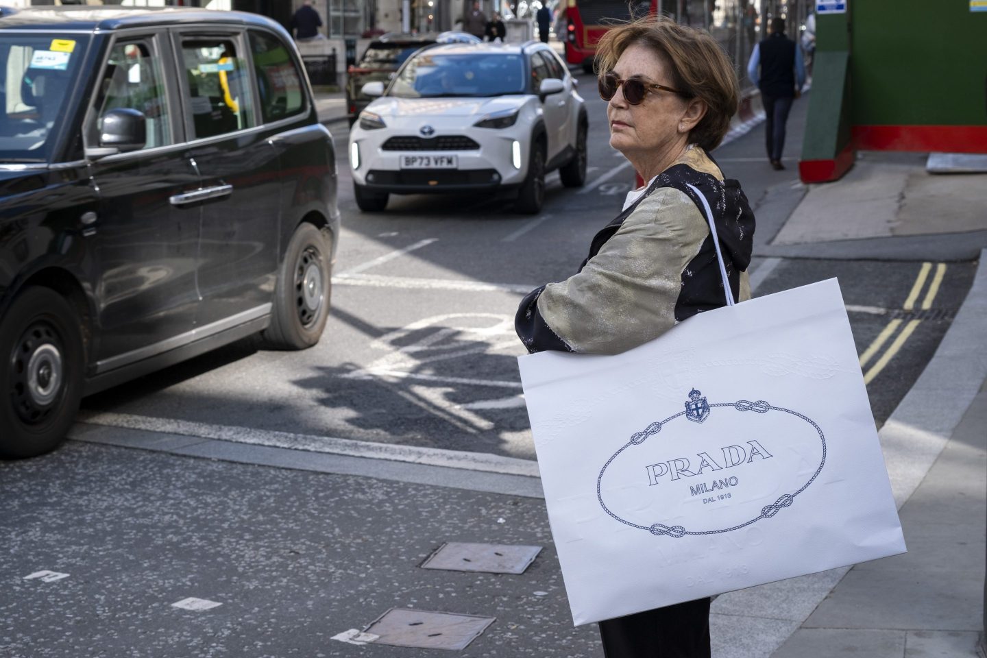 woman carrying a prada bag