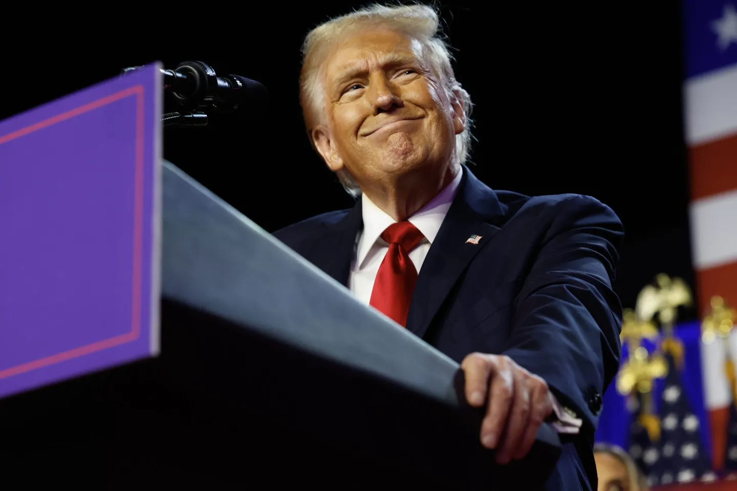 Donald Trump smirking at a podium