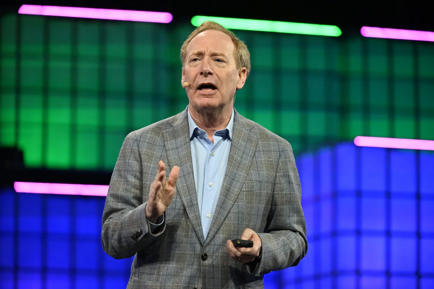 Microsoft President Brad Smith speaking on stage at Web Summit in Lisbon.