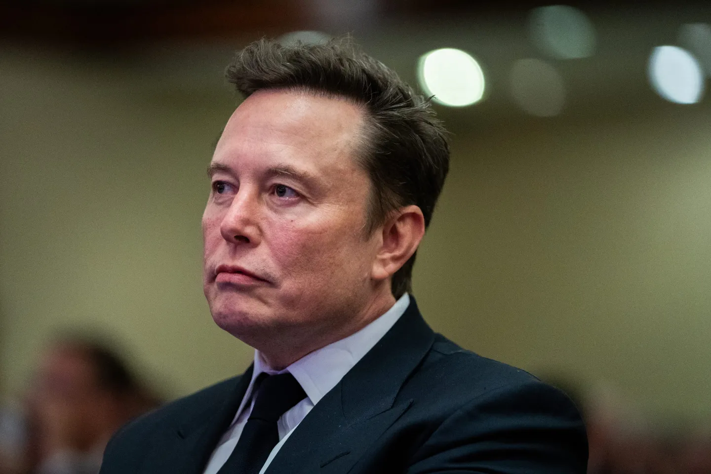 Elon Musk listens as US President-elect Donald Trump speaks during a House Republicans Conference meeting at the Hyatt Regency on Capitol Hill on November 13.