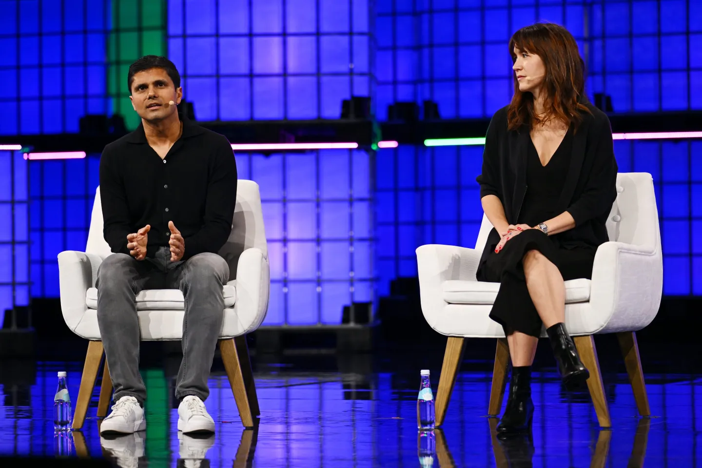 Moveworks CEO Bhavin Shah (left) on stage at Web Summit with Sarah Myers West of the AI Now Institute.