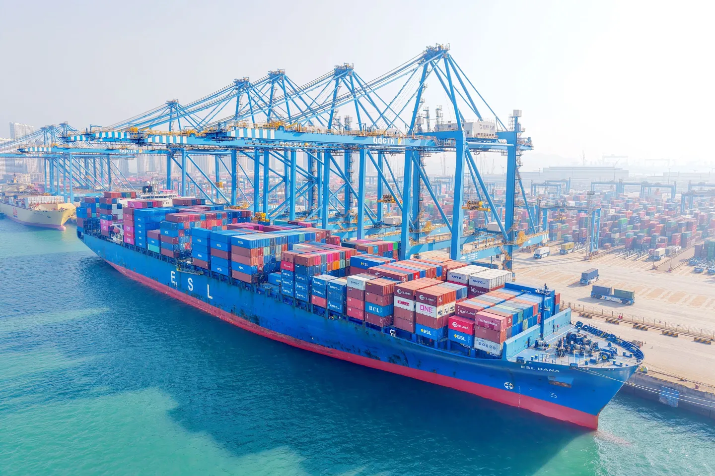 Cargo ships load and unload foreign trade containers at a fully automated terminal in Qingdao Port, Shandong province, China.