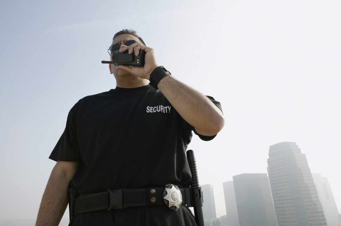 Security guard talks to client on the walkie talkie.