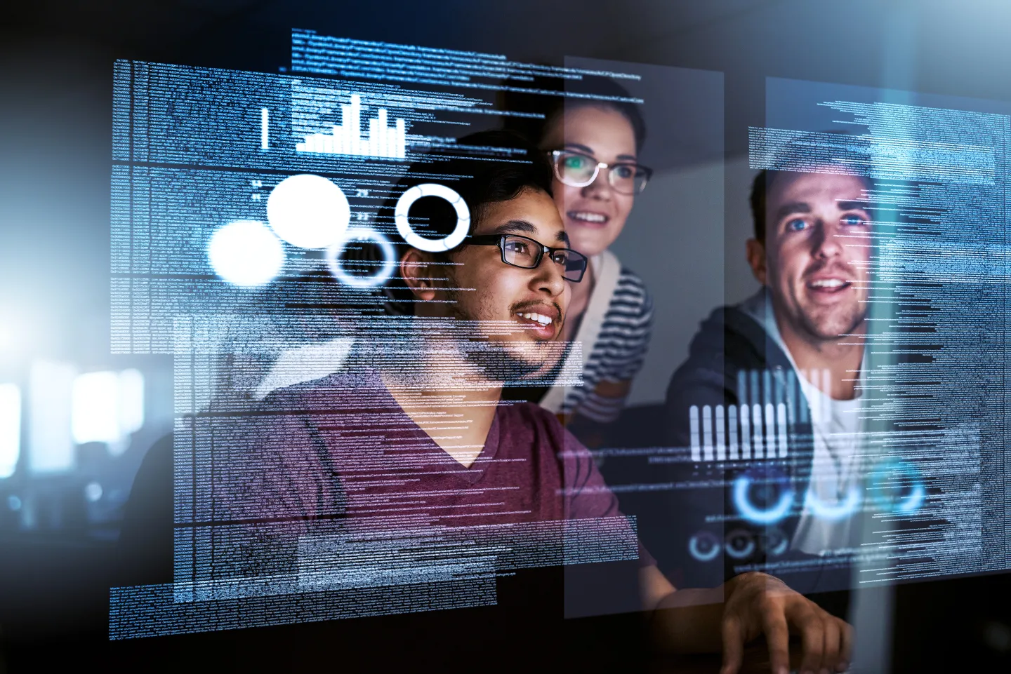 IT workers look at holograph screen that is full of text code.